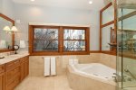 Primary bathroom offers jetted tub and steam shower